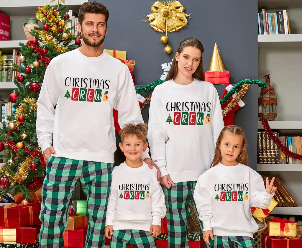 Woman and her family wearing a Christmas crew jumper with a matching festive design